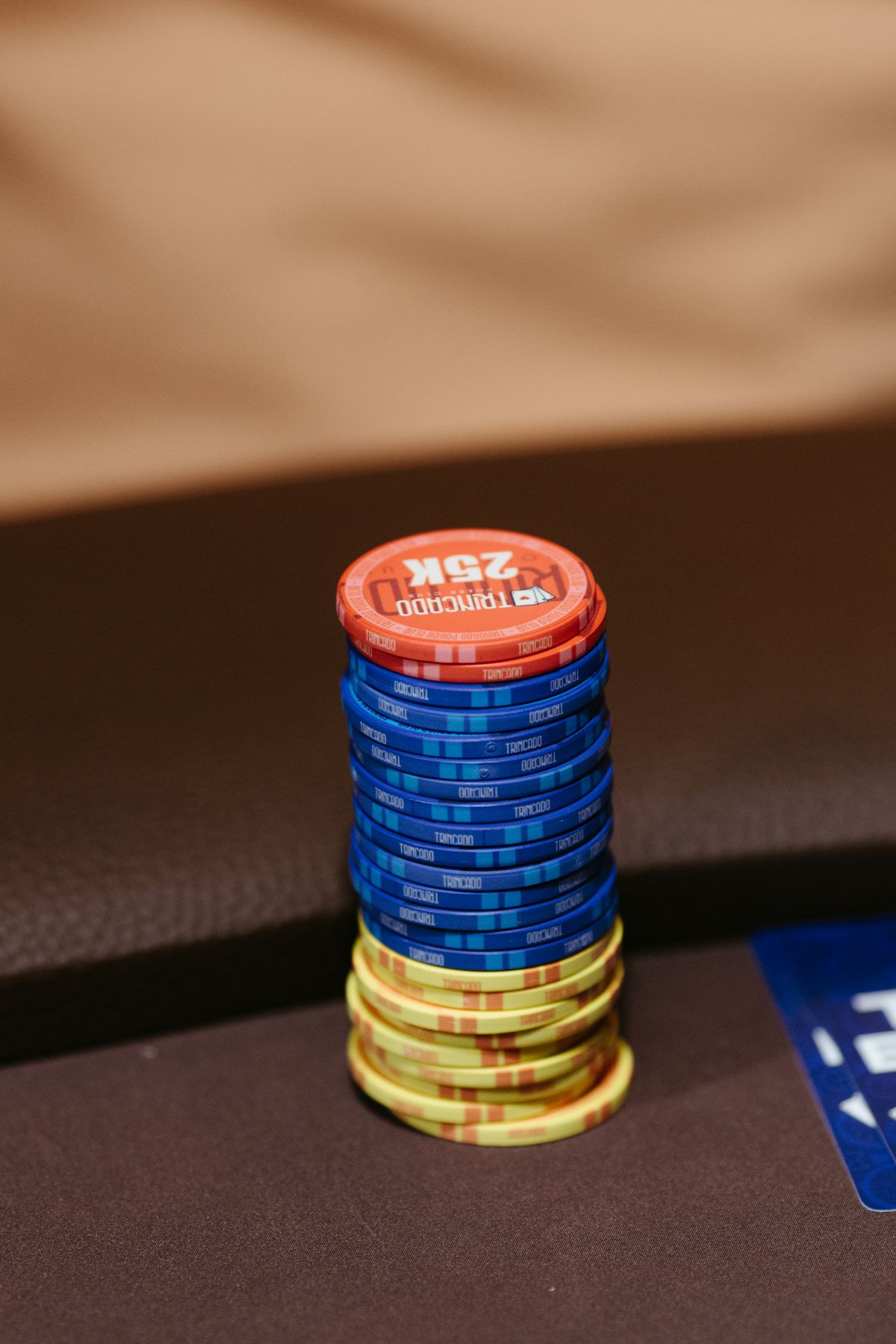 Poker chips stacked beside playing cards